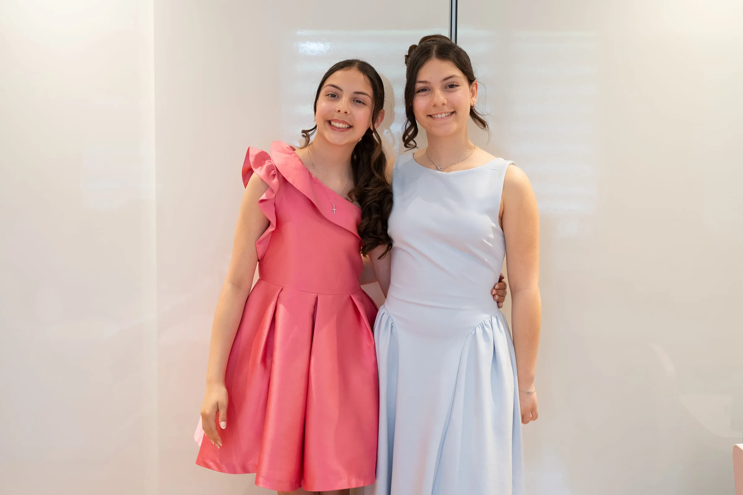 Two of the girls standing together in their confirmation clothes before leaving for the church