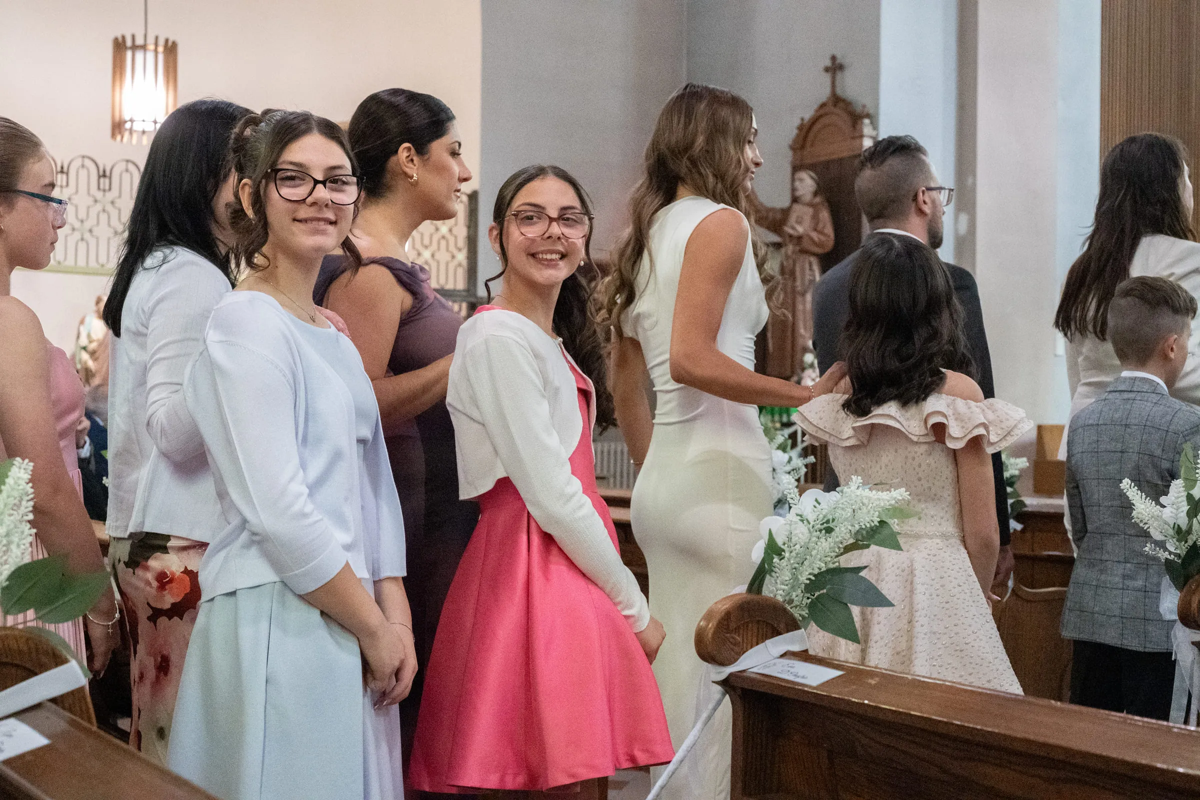 The confirmands waiting in the aisle with their flowers before the ceremony