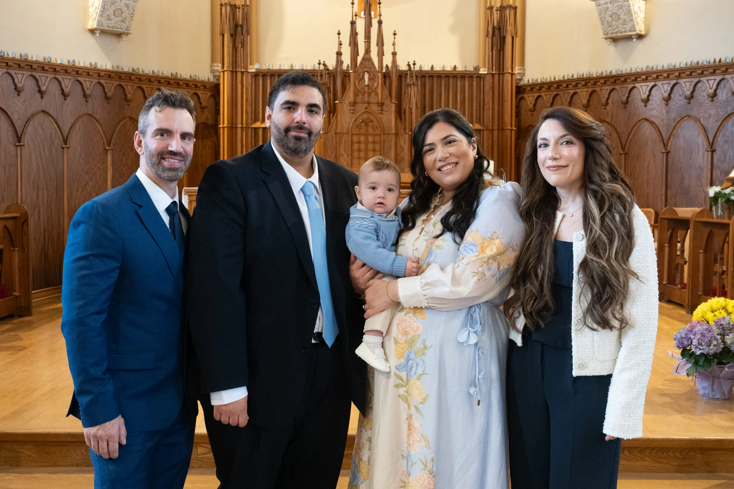The parents and godparents together with the baby at the altar